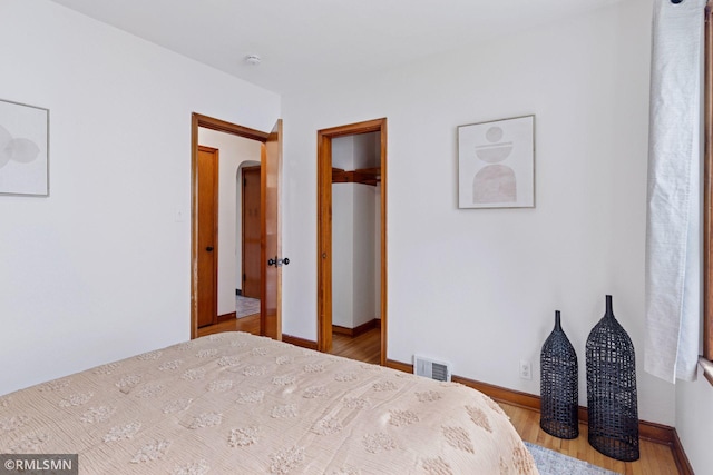 674 Wheelock Pkwy W, Saint Paul, MN 55117 - bedroom with wood finished floors and arched walkways
