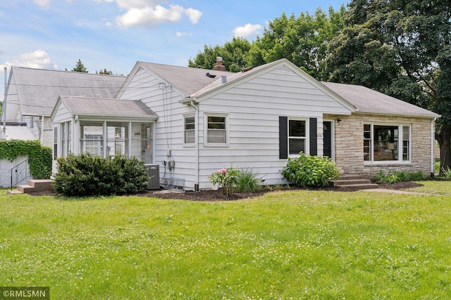 674 Wheelock Pkwy W, Saint Paul, MN 55117 - view of front of house with a front lawn, a sunroom, and stone siding