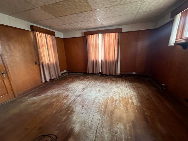 unfurnished room with hardwood / wood-style floors