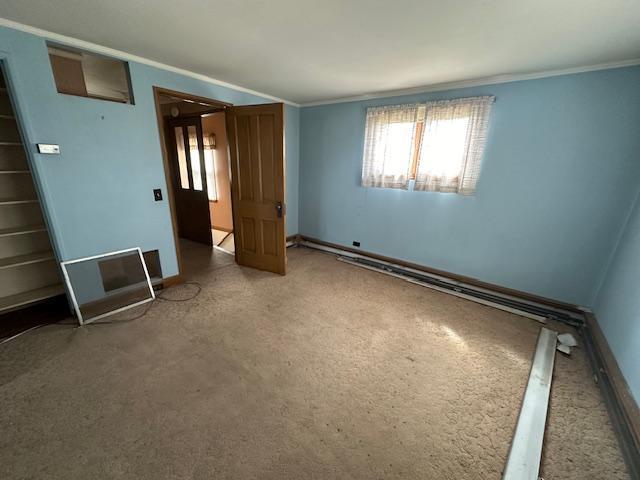 unfurnished bedroom with baseboards, carpet floors, and ornamental molding