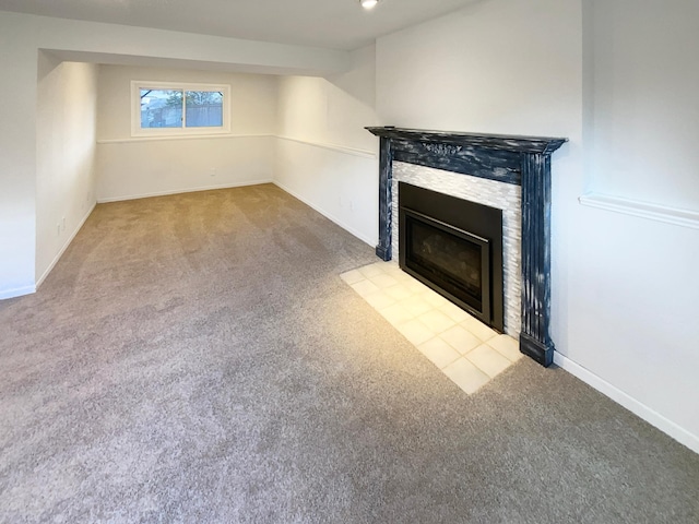 unfurnished living room with a fireplace with flush hearth, baseboards, and carpet flooring