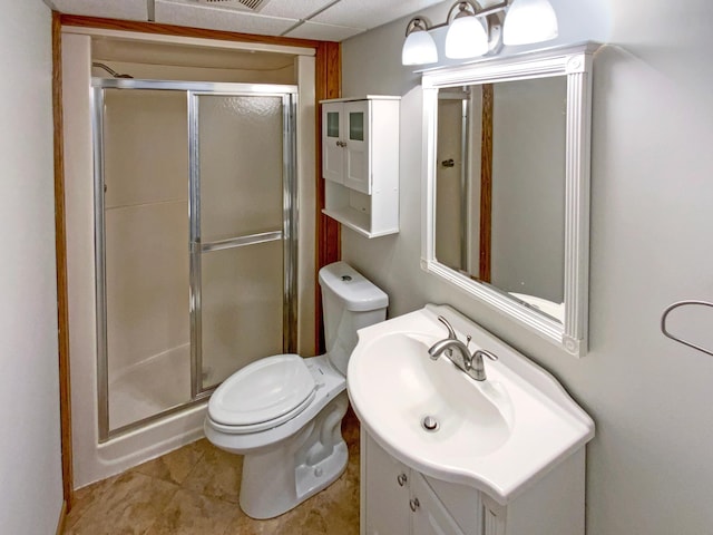 bathroom featuring tile patterned flooring, a shower stall, toilet, and vanity