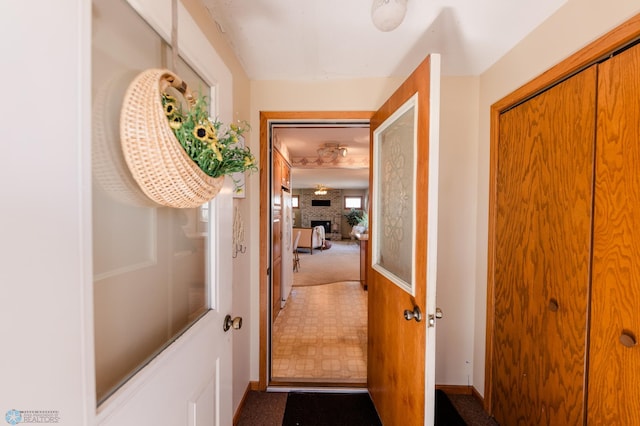 doorway to outside with carpet floors and baseboards