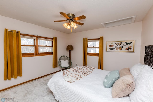 carpeted bedroom featuring attic access and ceiling fan
