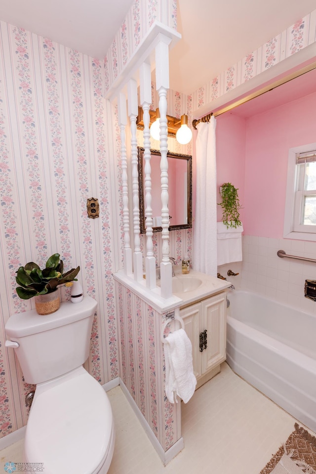 bathroom featuring a garden tub, toilet, and vanity