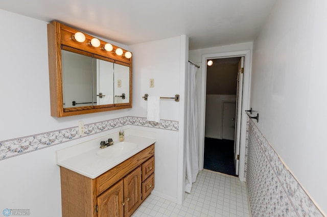 bathroom featuring tile patterned flooring, vanity, and a shower with curtain