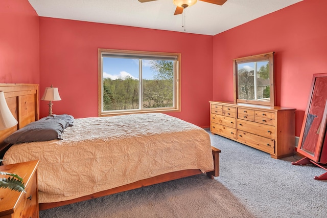 bedroom featuring multiple windows, ceiling fan, and carpet