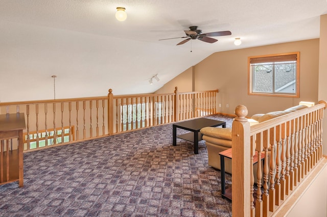 interior space featuring carpet flooring, lofted ceiling, and a ceiling fan