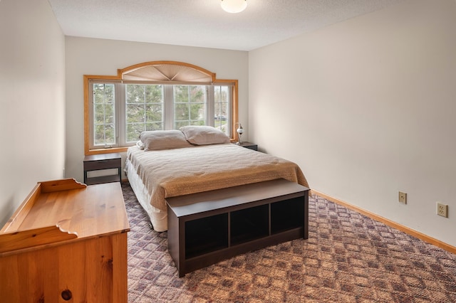 carpeted bedroom featuring baseboards