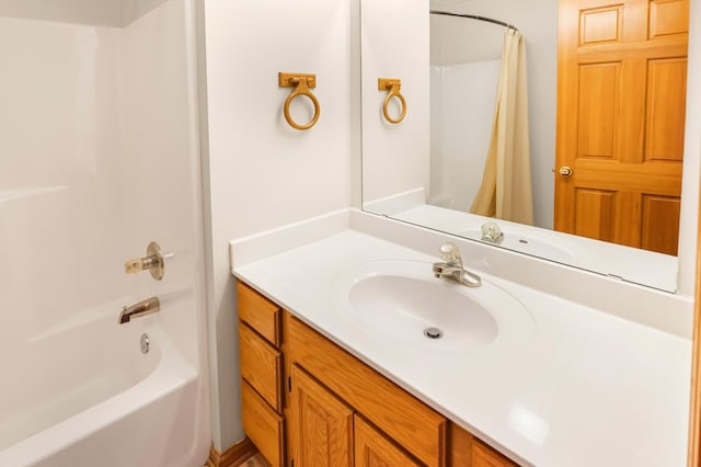 bathroom with shower / bathtub combination with curtain and vanity