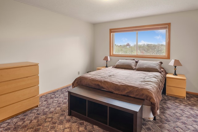 bedroom featuring baseboards and dark carpet