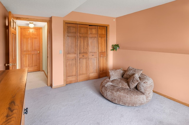 sitting room with light colored carpet and baseboards