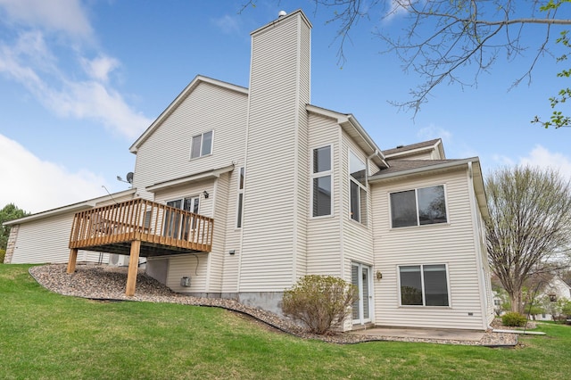 rear view of property featuring a yard, a deck, a patio, and a chimney