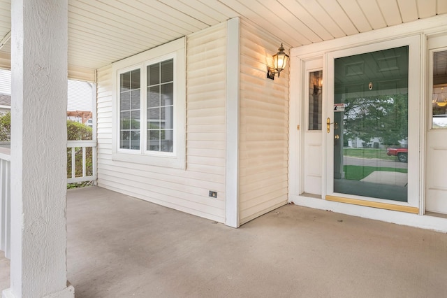 view of exterior entry featuring a porch