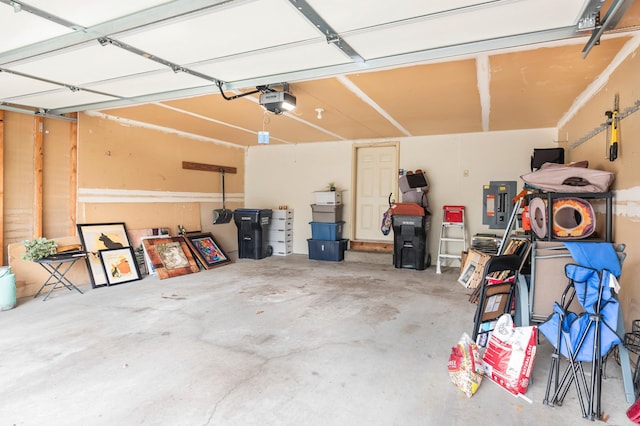 garage featuring electric panel and a garage door opener