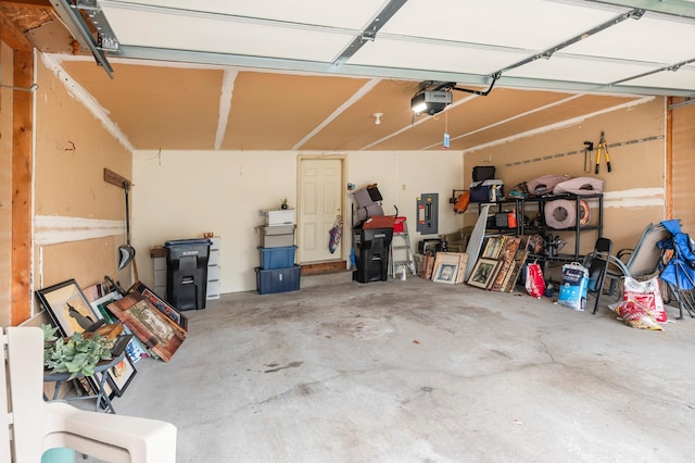 garage with electric panel and a garage door opener