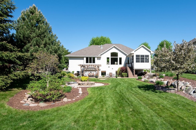 26 Deerwood Ct, North Mankato, MN 56003 - back of property with a pergola, a lawn, a sunroom, and stairway