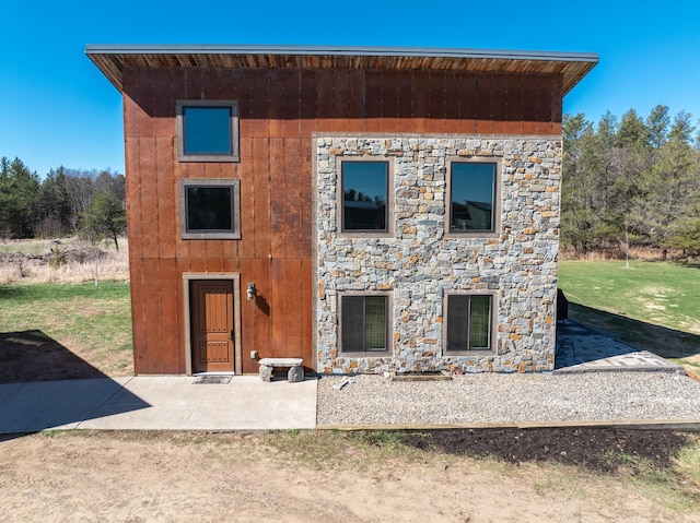 back of house with stone siding