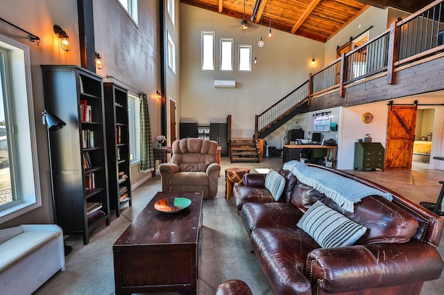 living room with beam ceiling, high vaulted ceiling, stairway, a barn door, and wood ceiling