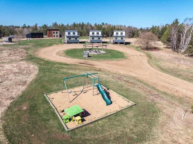 view of property's community with a yard and playground community
