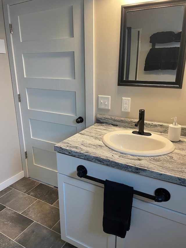 bathroom featuring vanity and baseboards