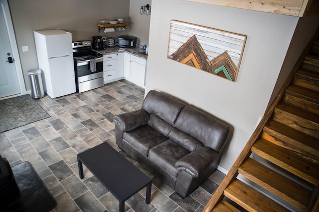 living area with stone finish flooring and stairs
