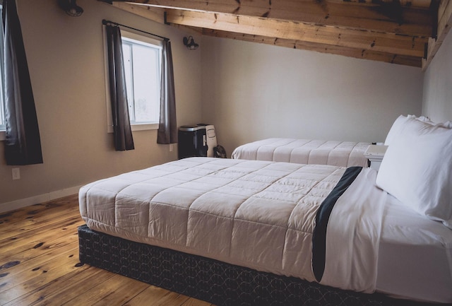 bedroom featuring baseboards and hardwood / wood-style flooring