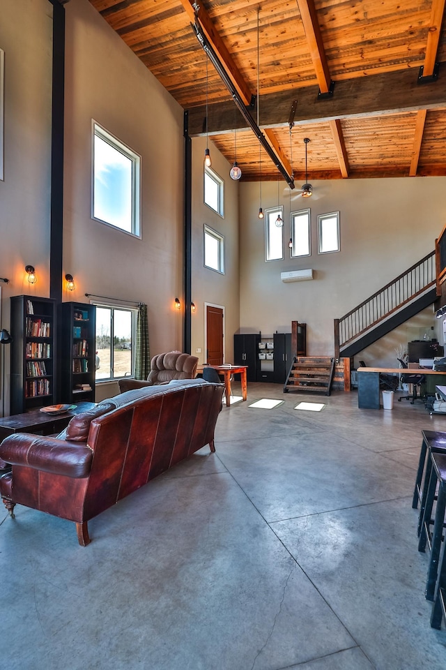 living room with beamed ceiling, concrete floors, wood ceiling, and a towering ceiling