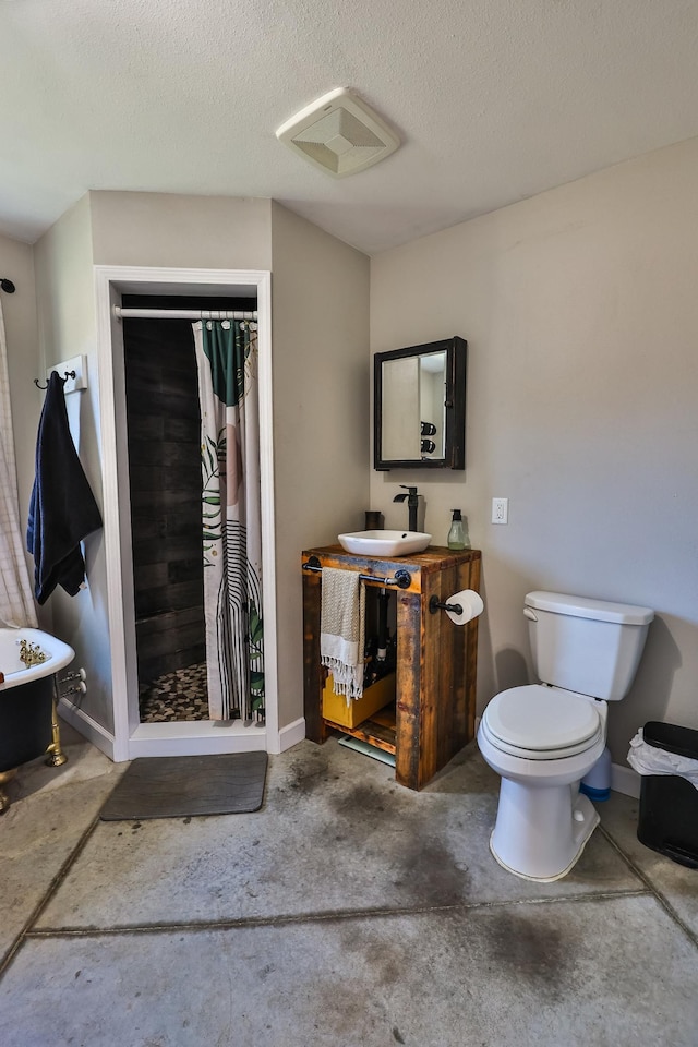 bathroom featuring toilet, visible vents, a shower stall, and a sink