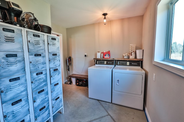 laundry area featuring baseboards, laundry area, and washing machine and dryer