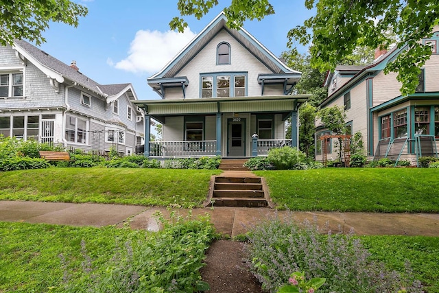 3622 Pleasant Ave, Minneapolis, MN 55409 - victorian home with a porch and a front lawn