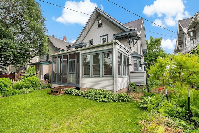 3622 Pleasant Ave, Minneapolis, MN 55409 - rear view of property with a sunroom and a yard