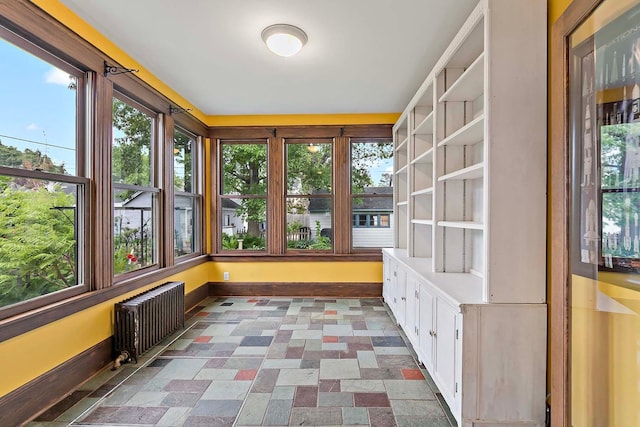 3622 Pleasant Ave, Minneapolis, MN 55409 - unfurnished sunroom featuring radiator heating unit, plenty of natural light, and baseboards