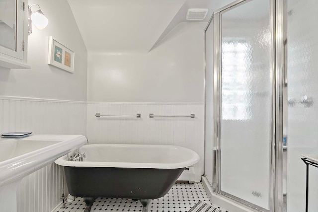 3622 Pleasant Ave, Minneapolis, MN 55409 - full bath with a freestanding bath, a wainscoted wall, a shower stall, tile patterned flooring, and lofted ceiling