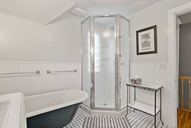3622 Pleasant Ave, Minneapolis, MN 55409 - full bath featuring a wainscoted wall, a freestanding bath, and a stall shower
