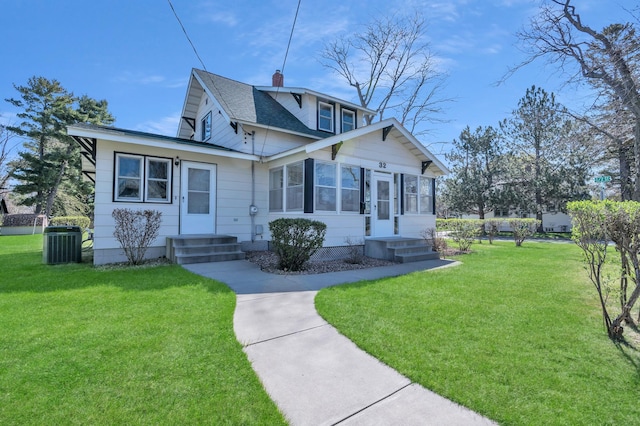 bungalow with a front lawn, central AC, and a chimney