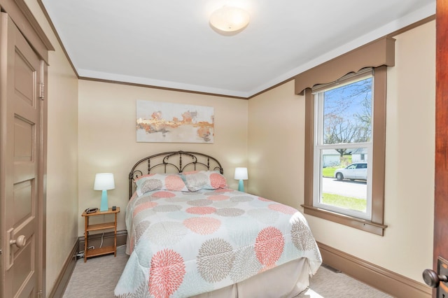 bedroom featuring crown molding, baseboards, carpet, and a baseboard heating unit