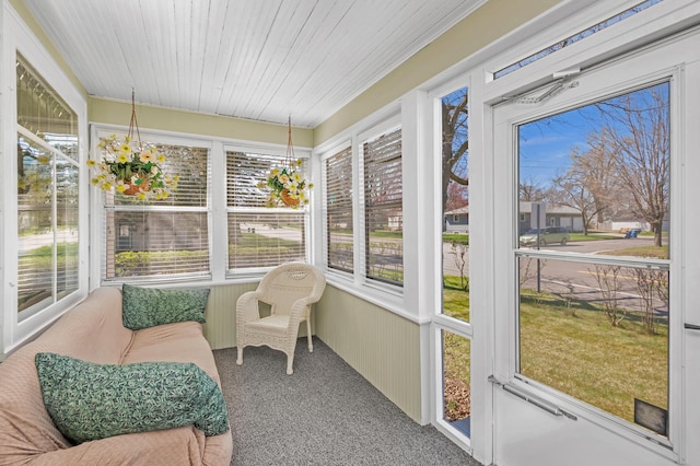 sunroom / solarium featuring carpet floors and a wealth of natural light