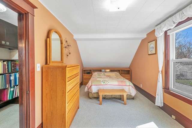 carpeted bedroom with vaulted ceiling