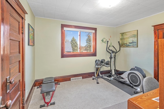 exercise area featuring carpet flooring, baseboards, and visible vents