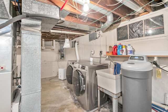 laundry area featuring washing machine and clothes dryer, laundry area, and a sink