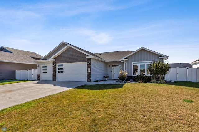 ranch-style house with fence, a front lawn, driveway, stone siding, and a garage