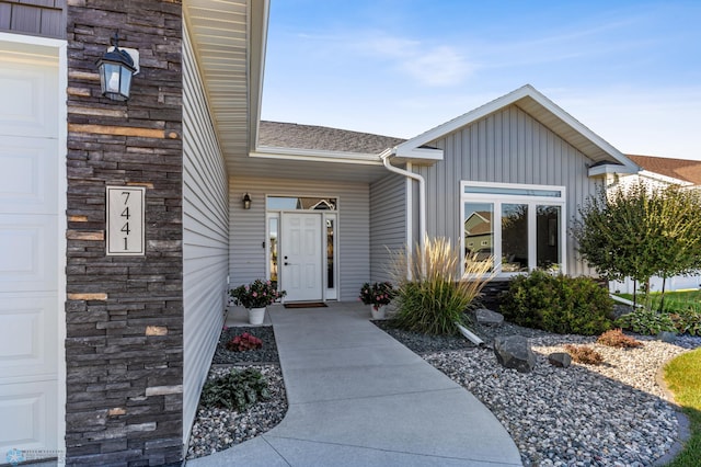 entrance to property with stone siding and board and batten siding