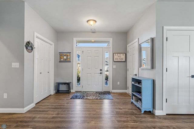 foyer with wood finished floors and baseboards