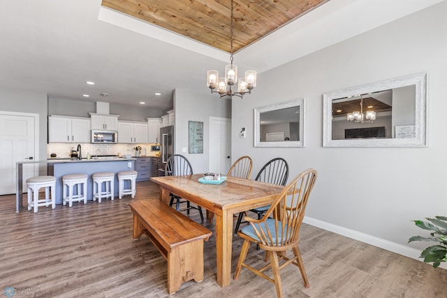 dining room featuring wooden ceiling, baseboards, a notable chandelier, and light wood-type flooring