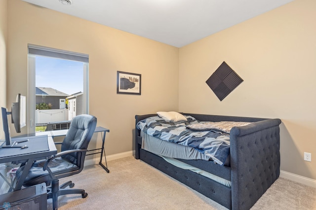 carpeted bedroom featuring baseboards