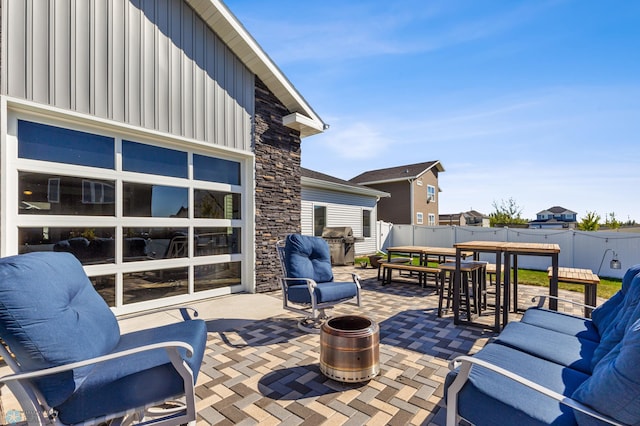 wooden deck featuring an outdoor living space, a patio area, outdoor dining space, grilling area, and fence
