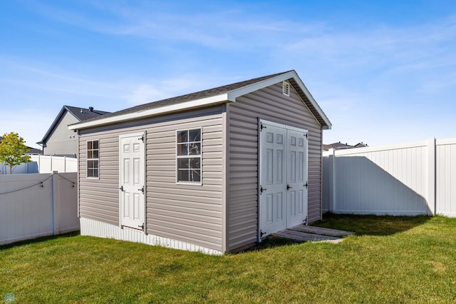 view of shed featuring fence