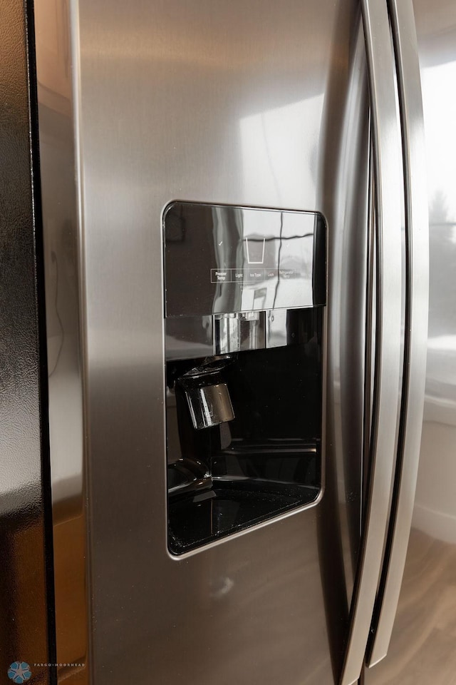 room details featuring stainless steel fridge with ice dispenser