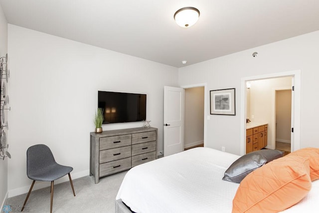 bedroom featuring light colored carpet and baseboards